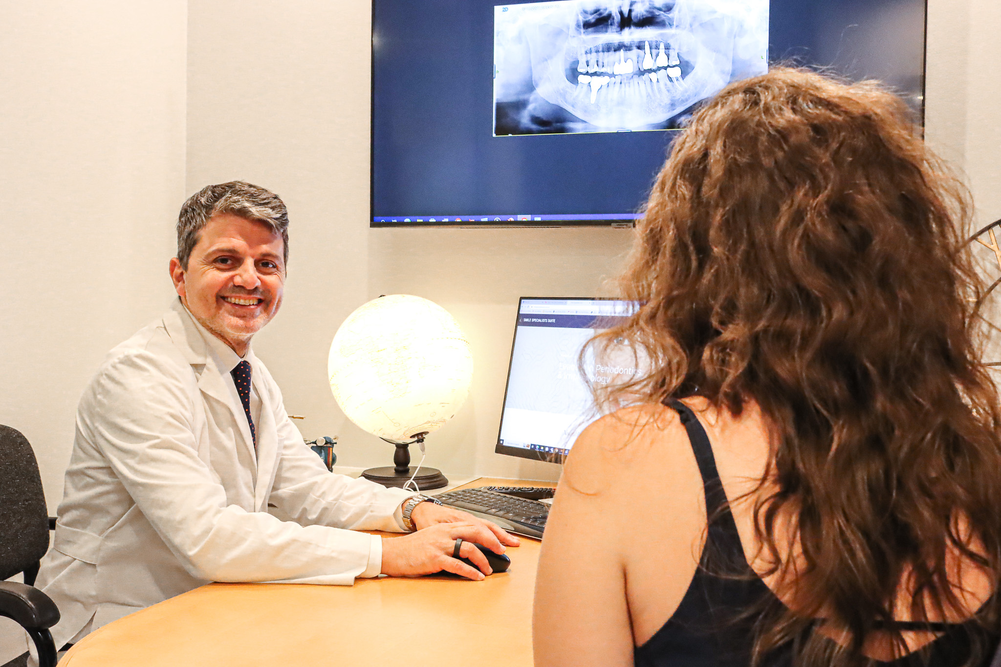 Prof Alex Quaranta consulting with a patient